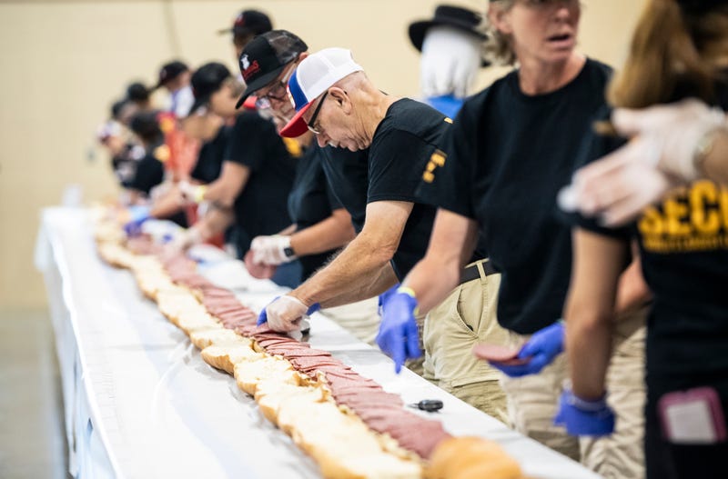 Volunteers assemble a 150-foot-long bologna sandwich at the Lebanon Area Fair on July 25, 2023, in Lebanon, Pa.