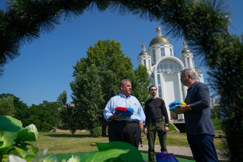Republican presidential candidate former New Jersey Gov. Chris Christie participates in a flowers laying ceremony near St. Andrew's Church in Bucha, on the outskirts of Kyiv, Ukraine, Friday, Aug. 4, 2023