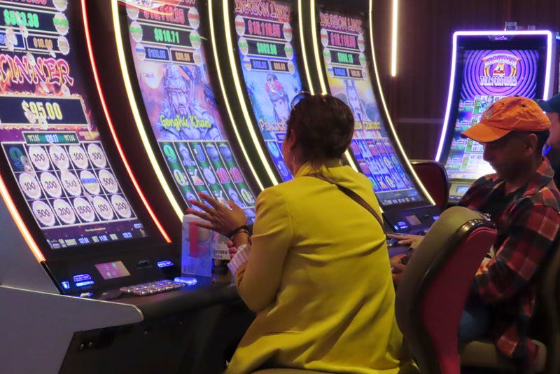 A gambler claps after a winning spin on a slot machine at the Hard Rock casino in Atlantic City N.J.