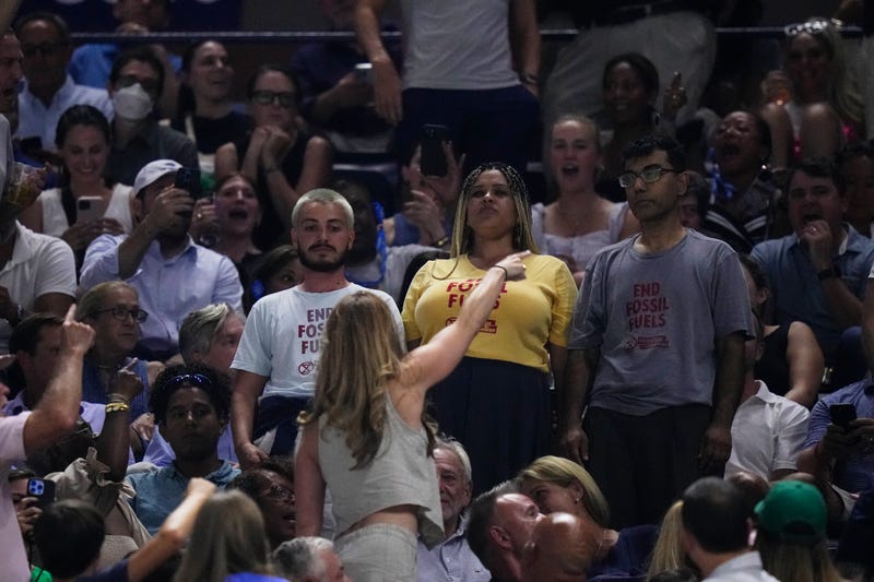 An audience member yells at protesters as they demonstrate at a match between Coco Gauff, of the United States, and Karolina Muchova, of the Czech Republic, during the women's singles semifinals of the U.S. Open tennis championships, Thursday, Sept. 7, 2023, in New York