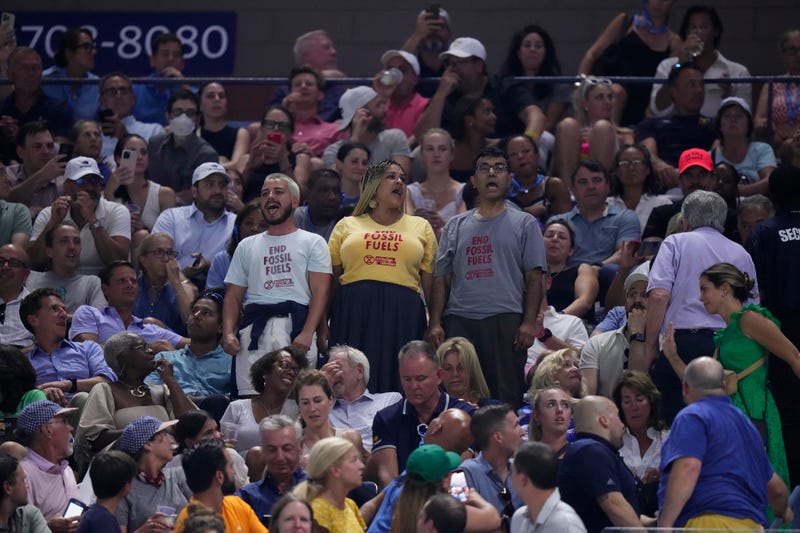 Protesters demonstrate at a match between Coco Gauff, of the United States, and Karolina Muchova, of the Czech Republic, during the women's singles semifinals of the U.S. Open tennis championships, Thursday, Sept. 7, 2023, in New York