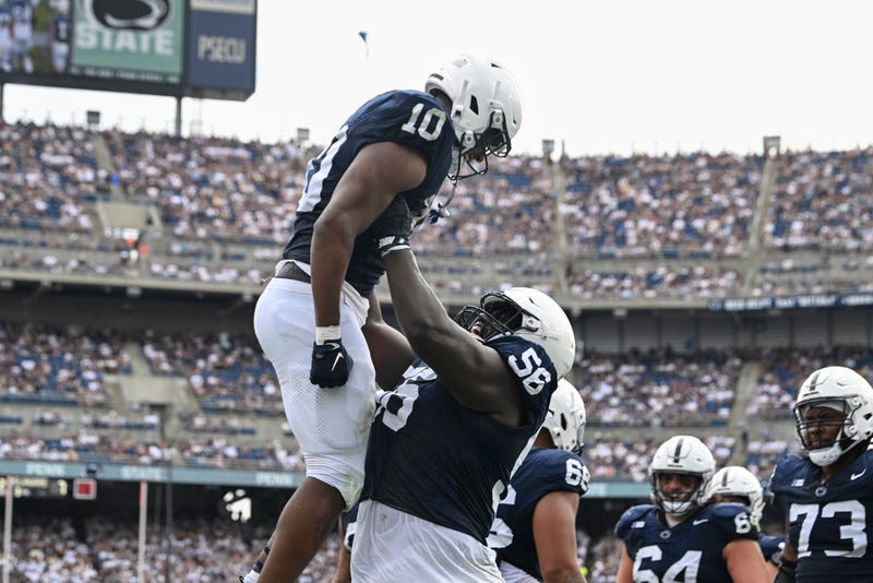 Penn State running back Nicholas Singleton (10) celebrates a touchdown with offensive lineman JB Nelson (56) during the first half of an NCAA college football game against Delaware, Saturday, Sept. 9, 2023, in State College, Pa.