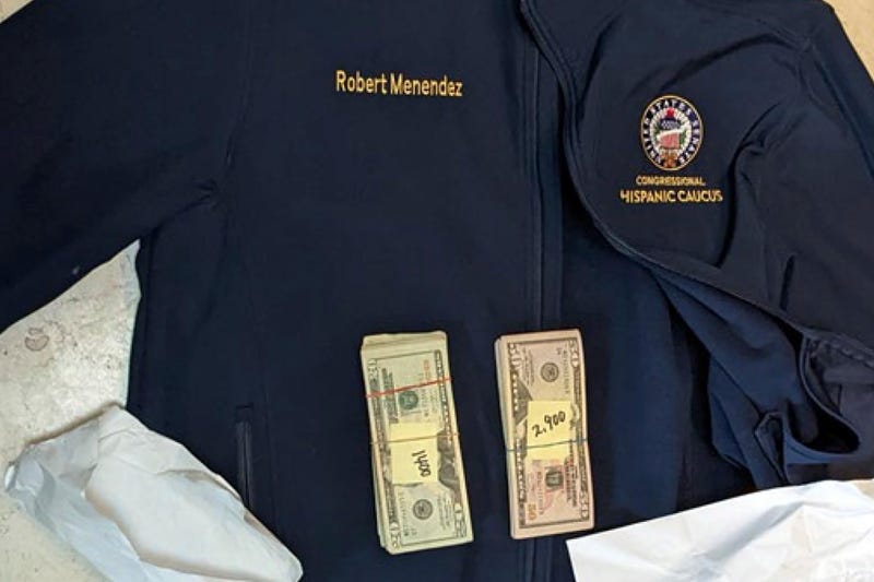 This photo, which was included in an indictment of U.S. Sen. Bob Menendez (D-N.J.), shows a jacket bearing Menendez's name, along with cash from envelopes found inside the jacket during a search by federal agents of the senator's home in Harrison, N.J., in 2022. Federal prosecutors announced charges of bribery against Menendez and his wife, Nadine Arslanian Menendez, on Friday, Sept. 22, 2023.