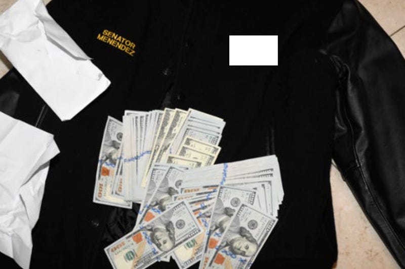 This photo, which was included in an indictment of U.S. Sen. Bob Menendez (D-N.J.), shows a jacket bearing Menendez's name, along with cash from envelops found inside the Jacket during a search by federal agents of the senator's home in Harrison, N.J., in 2022