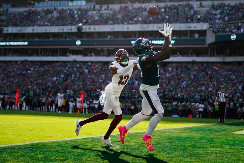 Philadelphia Eagles wide receiver A.J. Brown (11) reaches for a touchdown catch in front of Washington Commanders cornerback Emmanuel Forbes (13) during the second half of an NFL football game Sunday, Oct. 1, 2023, in Philadelphia. (AP Photo/Matt Rourke)