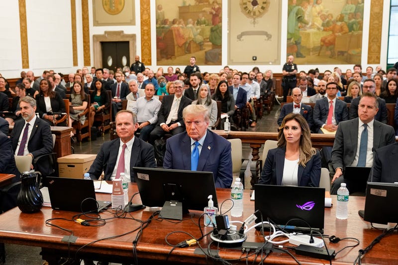 Attorney General Letitia James can be seen in the background (at upper left) as Donald Trump sits in court