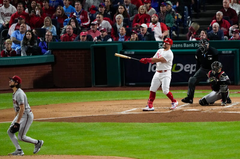 Philadelphia Phillies' Kyle Schwarber watches his home run off Arizona Diamondbacks starting pitcher Zac Gallen during the first inning in Game 1 of the baseball NL Championship Series in Philadelphia, Monday, Oct. 16, 2023.