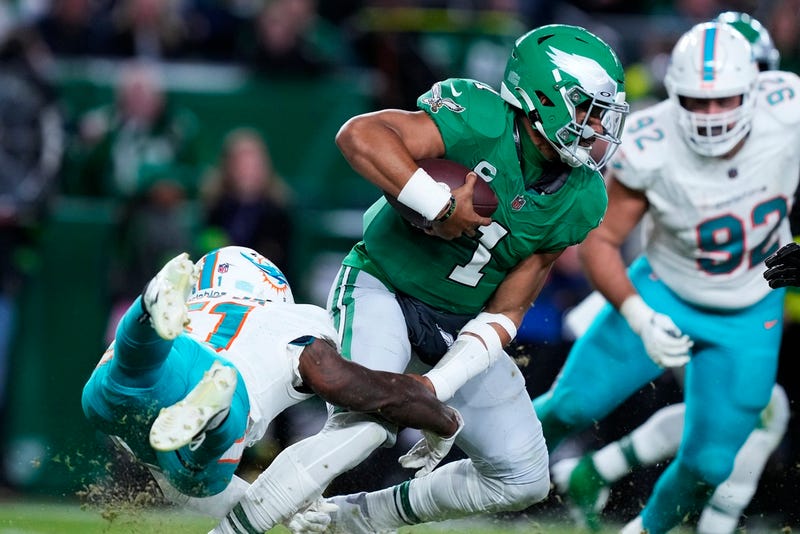 Philadelphia Eagles quarterback Jalen Hurts escapes a tackle from Miami Dolphins linebacker David Long Jr. on Sunday.