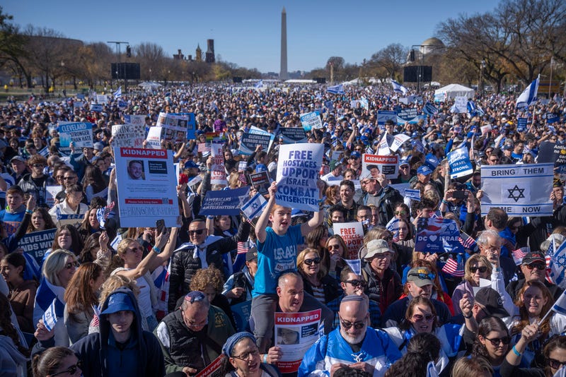 Participants hold signs as they stand on the National Mall at the March for Israel on Tuesday, Nov. 14, 2023, in Washington.