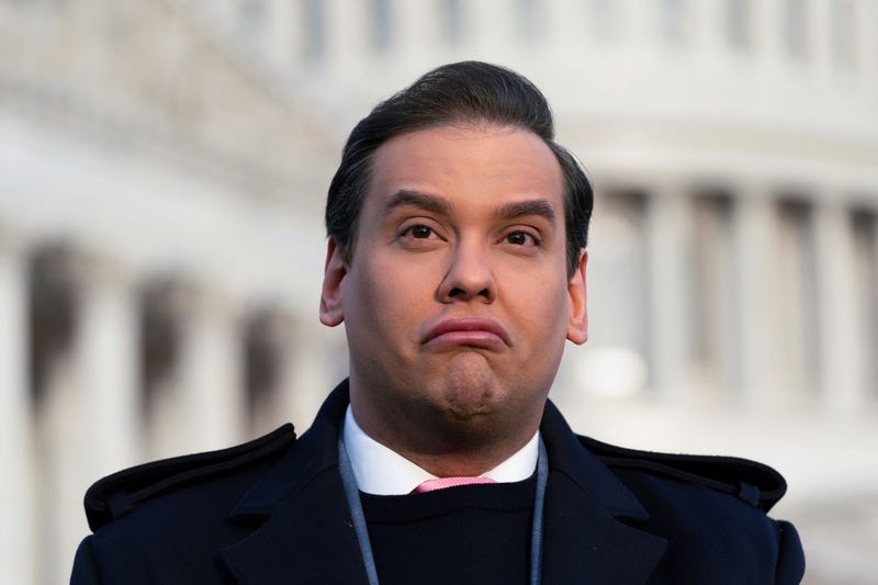 Rep. George Santos, R-N.Y., faces reporters at the Capitol in Washington, early Thursday, Nov. 30, 2023