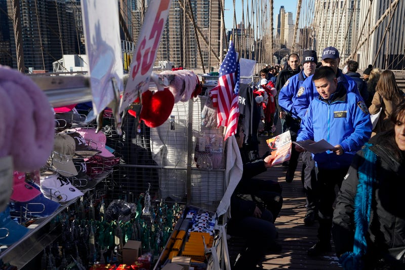 Police officers had out notices to vendors on the Brooklyn Bridge in New York, Tuesday, Jan. 2, 2024