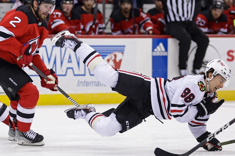  Connor Bedard falls to ice after hit from Brendan Smith