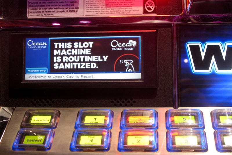 A sign on a slot machine at Ocean Casino Resort in Atlantic City, New Jersey, indicates it would be routinely sanitized after the casino reopens a month later.