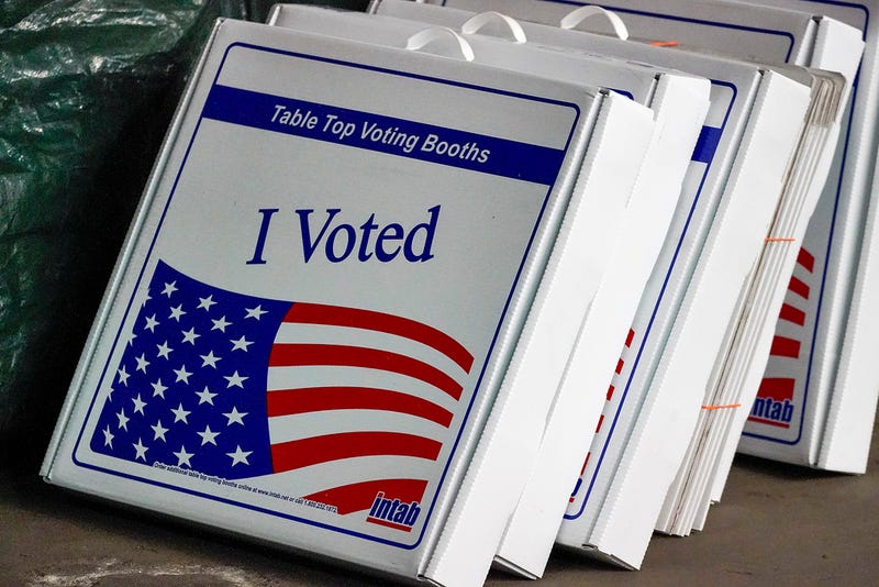 Table top voting booths are stored at the Allegheny County Election Division warehouse on the Northside of Pittsburgh, Friday, Nov. 6, 2020. New data from automatic voter registration at Pennsylvania driver’s license centers shows that sign-ups have grown but remain almost evenly divided between the political parties in the presidential battleground state. (AP Photo/Gene J. Puskar, File)