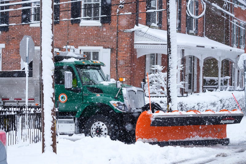 A plow operator works to clear snow during a winter storm in Doylestown, Pa., on Tuesday.