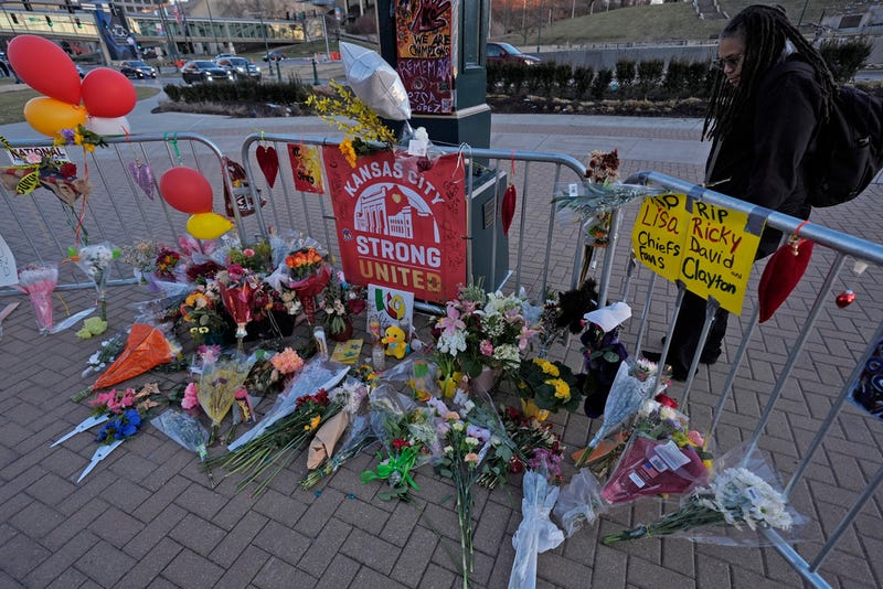 A person views a memorial dedicated to the victims of last week's mass shooting in front of Union Station