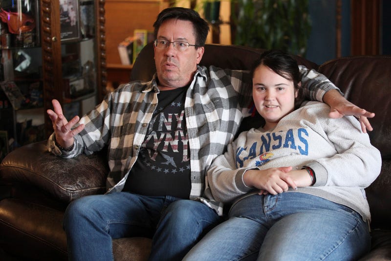 Rick Elskamp sits with his oldest daughter, Sheridan, and discusses the frustrations of having his 23-year-old daughter on a waiting list for 10 years
