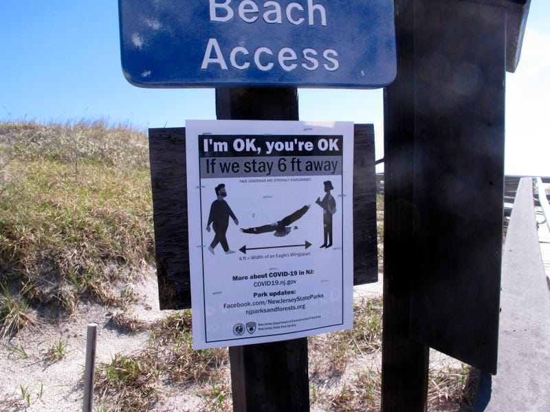 social distancing sign on beach