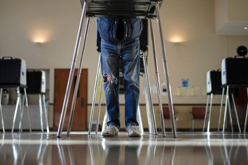 A voter fills out their primary election ballot