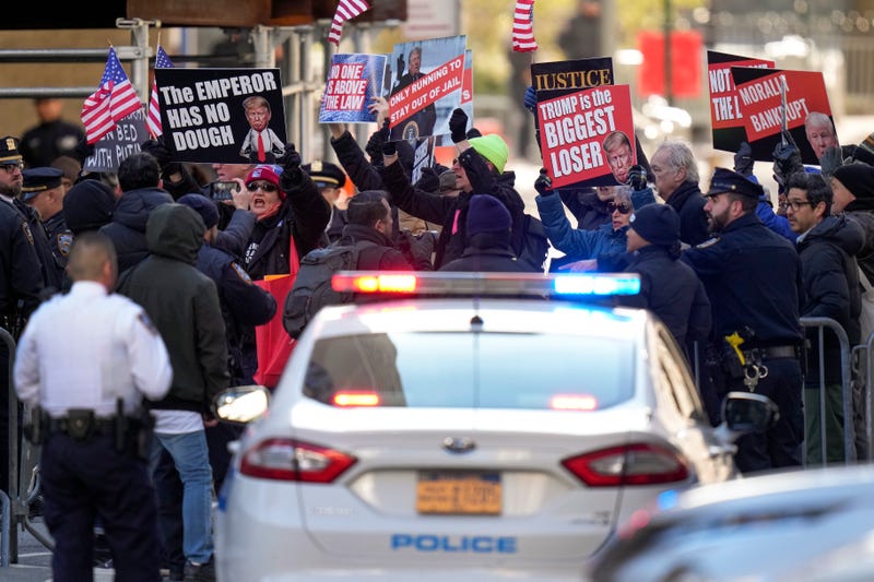 Protestors demonstrate outside Manhattan criminal court while awaiting the arrival of former President Donald Trump, Monday, March 25, 2024, in New York