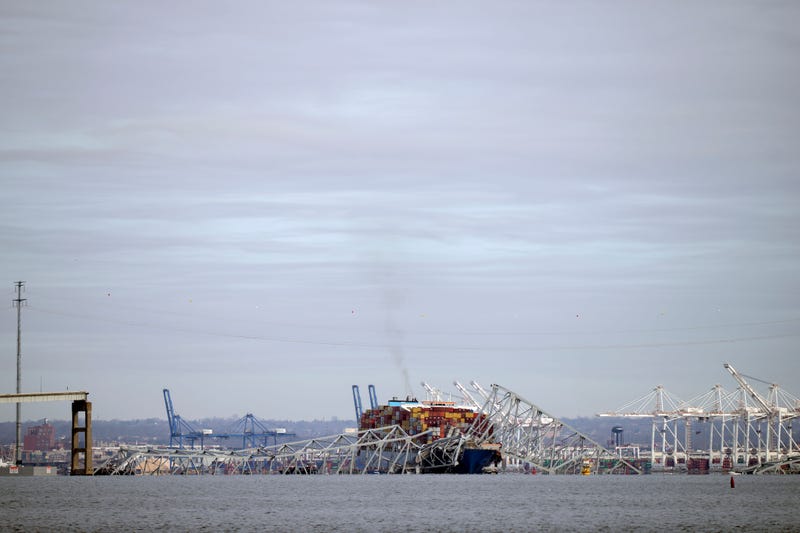 A container ship rests against the wreckage of the Francis Scott Key Bridge on Tuesday, March 26, 2024, as seen from Pasadena, Md. The container ship rammed into the major bridge in Baltimore early Tuesday, causing it to collapse in a matter of seconds and creating a terrifying scene as several vehicles plunged into the chilly river below. 