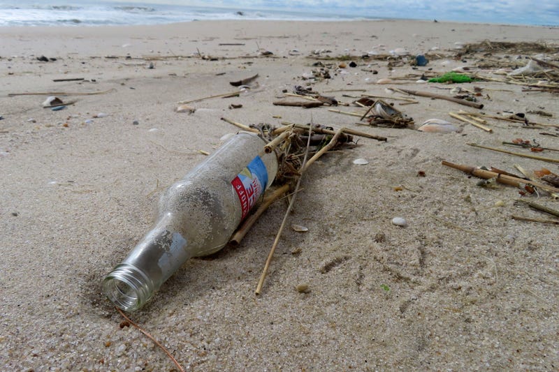 An alcoholic beverage bottle sits on the sand in Brick N.J. on Thursday, April 4, 2024, the day that the Clean Ocean Action Environmental Group released a report showing that volunteers picked up and disposed of 176,206 items of trash along New Jersey's 127-mile coastline last year