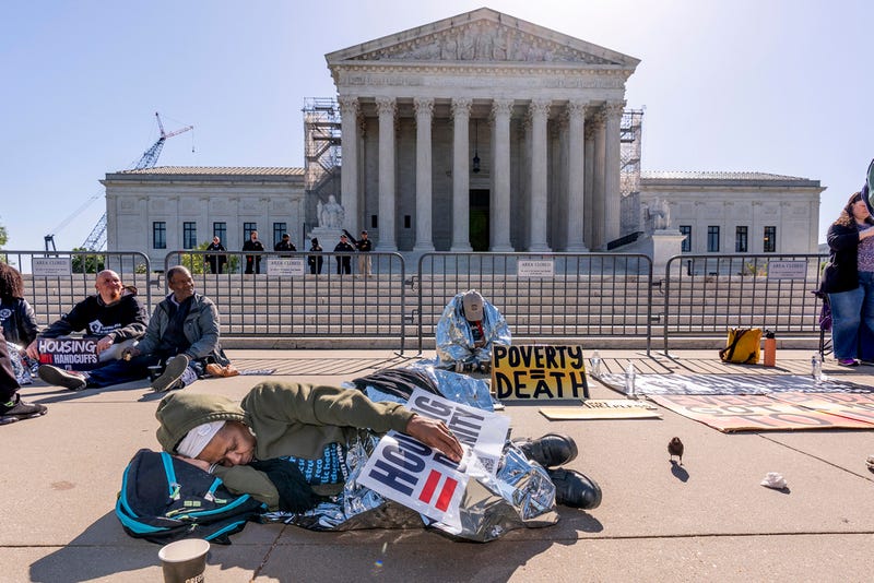 Activists demonstrate at the U.S. Supreme Court on Monday, April 22, as the justices consider a challenge to rulings that found punishing people for sleeping outside when shelter space is lacking amounts to unconstitutional cruel and unusual punishment.