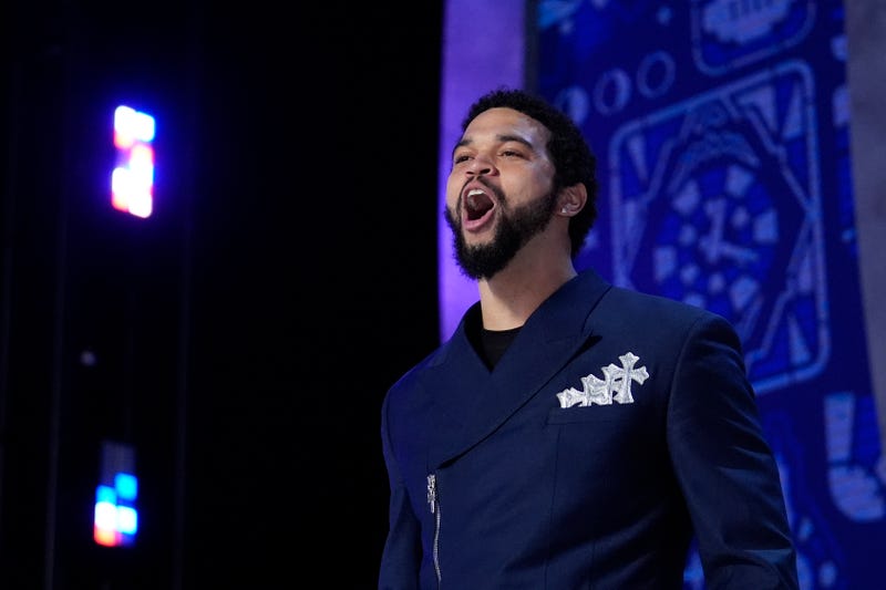 Caleb Williams walks on stage before the first round