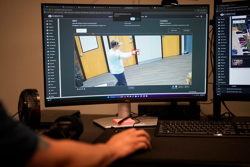 ZeroEyes analyst Mario Hernandez demonstrates the use of artificial intelligence with surveillance cameras to identify visible guns at the company's operations center