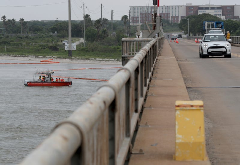 Crews monitor spill booms at the Pelican Island bridge in Galveston, Texas on Thursday, May 16, 2024, after a barge collided with the bridge Tuesday causing a partial collapse of the bridge and spilling vacuum gas oil into Galveston Bay.
