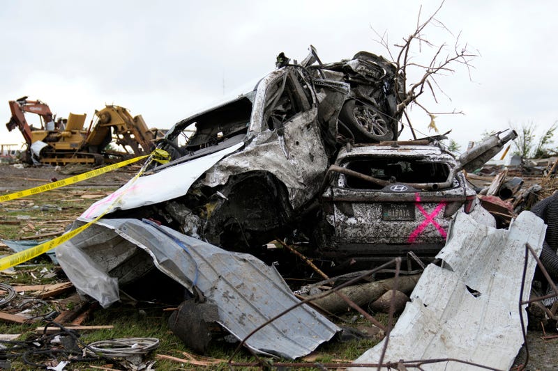 Damaged cars sit piled up