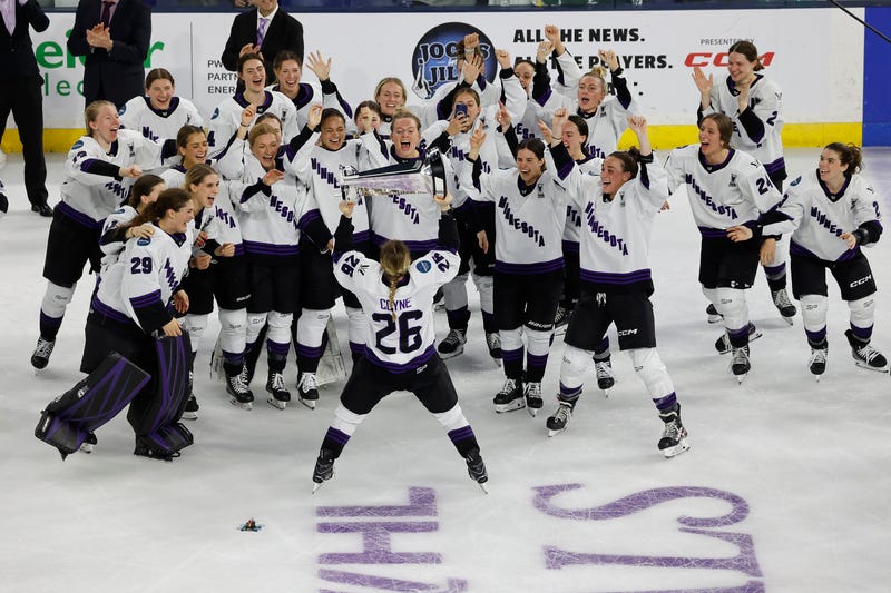 Minnesota captain Kendall Coyne Schofield (26) takes the trophy to her team after defeating Boston to win the PWHL Walter Cup, Wednesday May 29, 2024, in Lowell, Mass.
