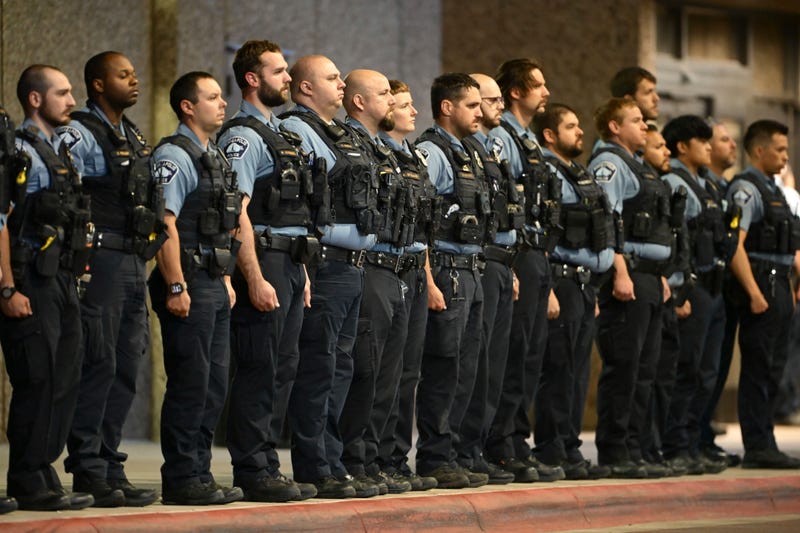 Members of law enforcement gather outside Hennepin County Medical Center in Minneapolis, Thursday, May 30, 2024, 2024, following the fatal shooting of officer Jamal Mitchell.