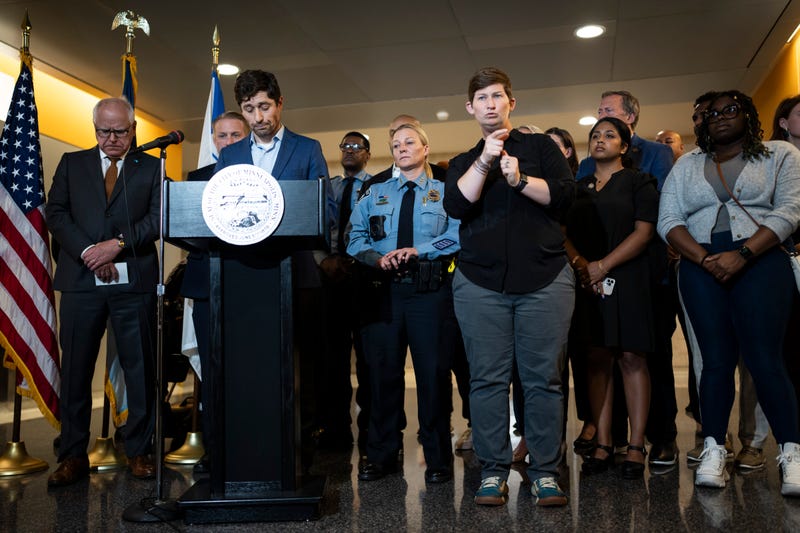 Mayor Jacob Frey, at podium, speaks at a news conference following a fatal shooting, in Minneapolis, Thursday, May, 30, 2024. Minneapolis police Officer Jamal Mitchell was among those killed.