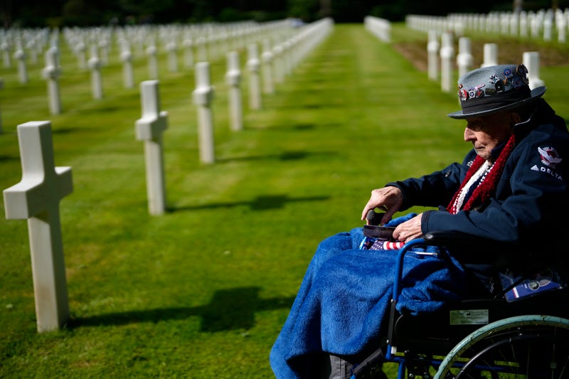 World War II and D-Day veteran Jake Larson of Owatonna, Minnesota visits the grave of a soldier from his unit at the Normandy American Cemetery in Colleville-sur-Mer, France.