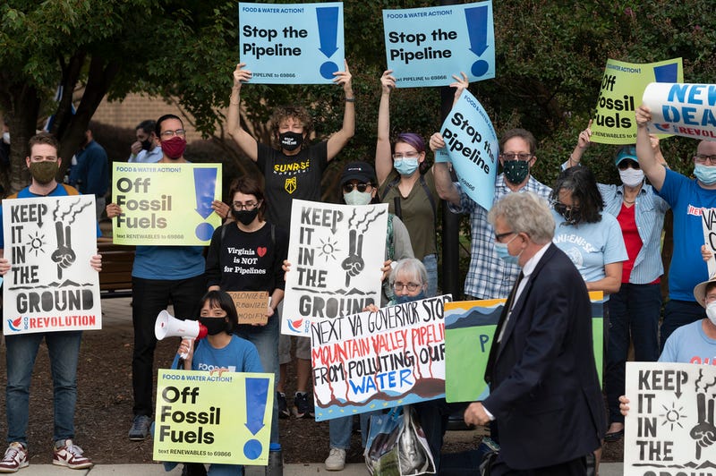 FILE - Demonstrators against the Mountain Valley Pipeline protest at Northern Virginia Community College where gubernatorial candidates, Terry McAuliffe and Glenn Youngkin are debating each other, in Alexandria, Va., Tuesday, Sept. 28, 2021. The hotly contested East Coast natural gas pipeline was given the go-ahead Tuesday, June 11, 2024, to start operating, six years after construction began at more than double its original estimated cost.
