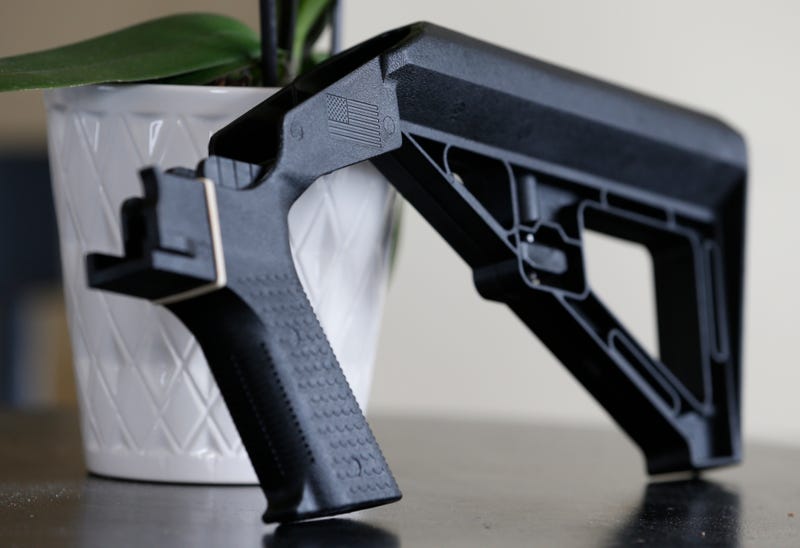 A bump stock is displayed in Harrisonburg, Va., on March 15, 2019. The Supreme Court has struck down a Trump-era ban on bump stocks, a gun accessory that allows semi-automatic weapons to fire rapidly like machine guns. 