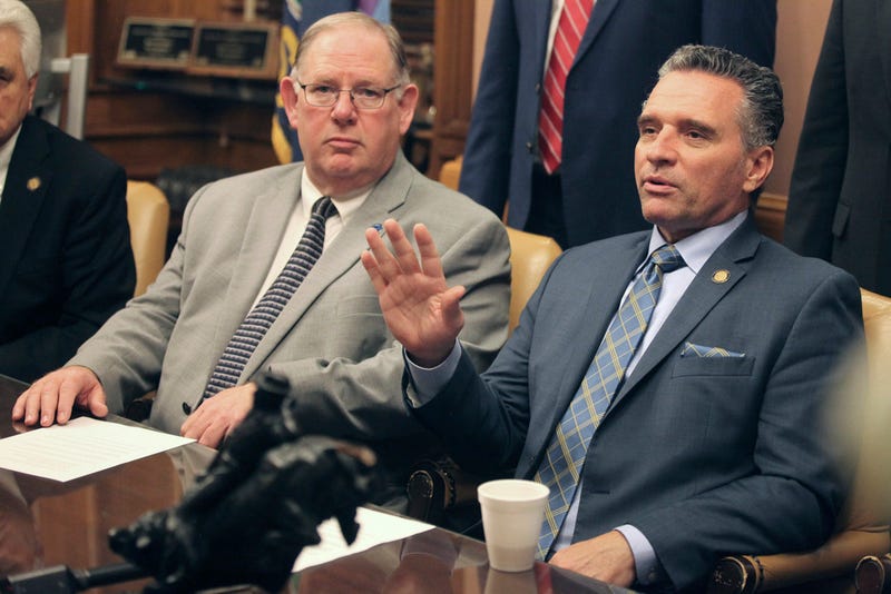 Kansas Senate President Ty Masterson, right, R-Andover, speaks to reporters during a news conference as House Speaker Dan Hawkins, left, R-Wichita, watches
