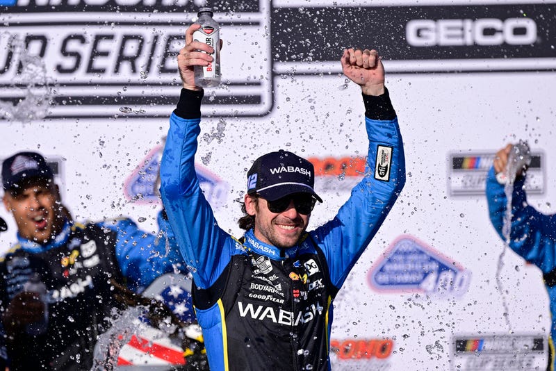Ryan Blaney celebrates in the victory lane after winning a NASCAR Cup Series auto race at Pocono Raceway, Sunday, July 14, 2024, in Long Pond, Pa.