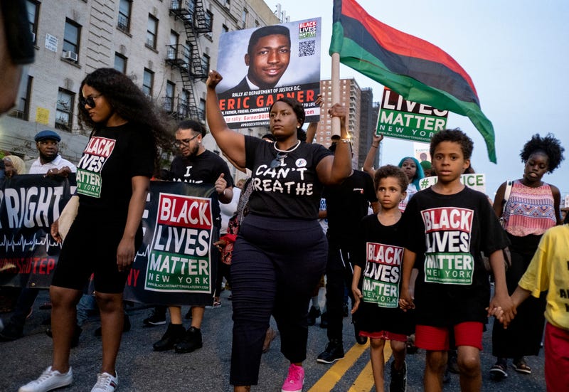 Activists with Black Lives Matter protest in the Harlem neighborhood of New York, Tuesday, July 16, 2019, in the wake of a decision by federal prosecutors who declined to bring civil rights charges against NYPD officer Daniel Pantaleo in the 2014 chokehold death of Eric Garne