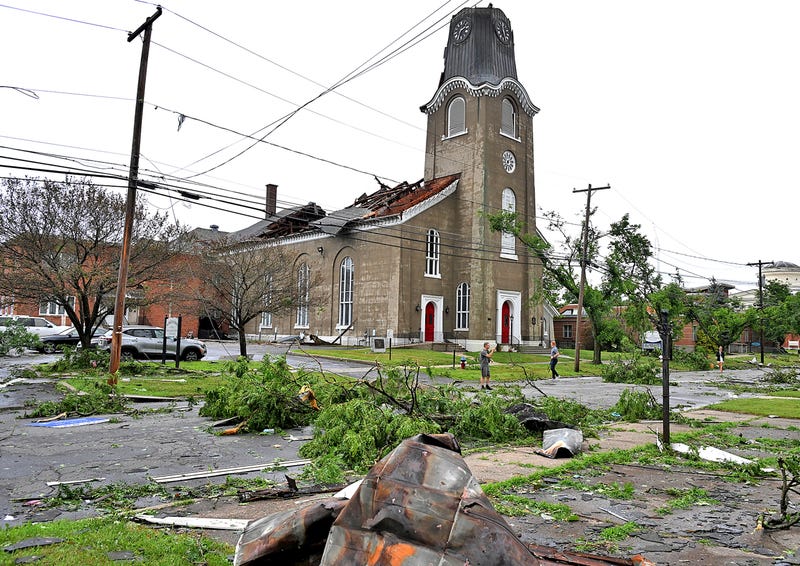 People survey the collapsed roof and missing spire of the Rome First Presbyterian Church, and downed trees from a tornado, in Rome, N.Y., Tuesday, July 16, 2024