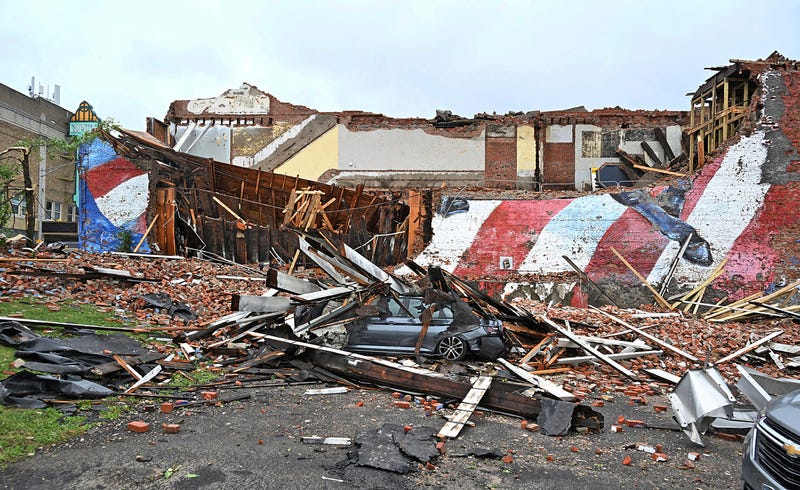 A car is crushed by the fallen building that hosted the Gansevoort mural that was struck by a tornado, in Rome, N.Y., Tuesday, July 16, 2024
