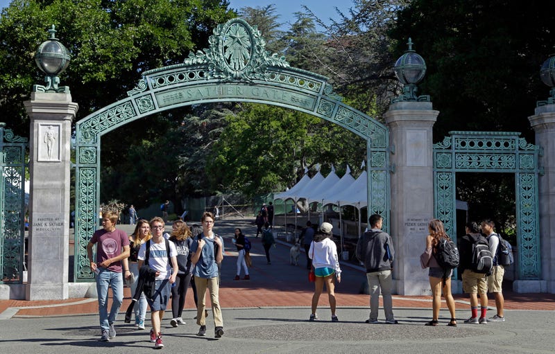 FILE - Students walk past Sather Gate on the University of California, Berkeley campus in Berkeley, Calif., April 21, 2017. The University of California Board of Regents voted Thursday, July 18, 2024, to ban employees from posting political statements on the homepages of university websites, saying such comments could be interpreted as the university system's official view. 