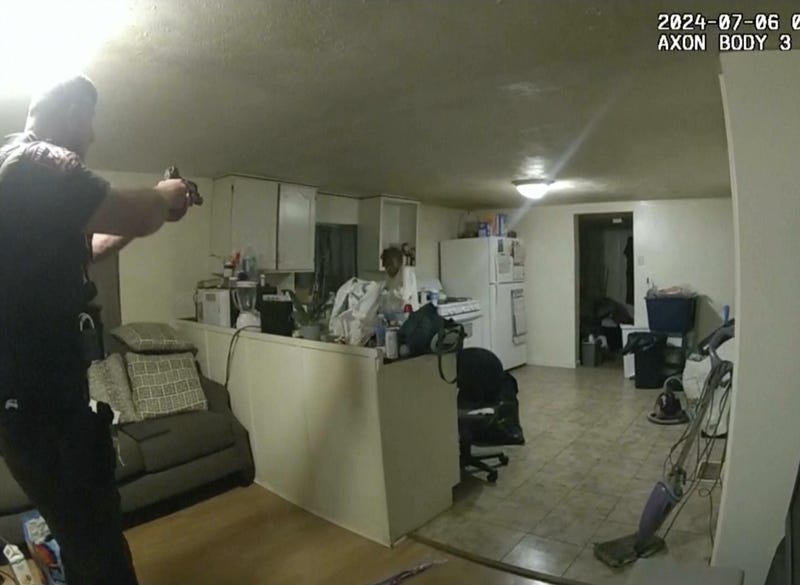 A still taken from body-worn camera footage shows Sangamon County Sheriff's Deputy Sean Grayson point his gun at Sonya Massey, seconds before he shot and killed her. Massey had called 911 earlier to report a prowler outside of her home.