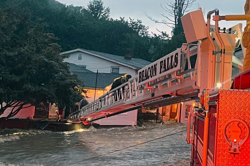 This photo provided by Beacon Hose Co. No. 1, a fire station in Beacon Falls, Connecticut, shows members of Beacon Hose Co. rescuing people from the Brookside Inn in Oxford, Conn., Sunday, Aug. 18, 2024