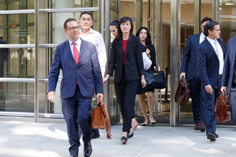Former New York Governor Kathy Hochul aide Linda Sun, center, and her husband, Christopher Hu, second from left, leave Brooklyn Federal Court after their arraignment, Tuesday, Sept. 3, 2024, in New York