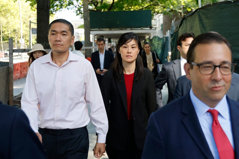 Attorney Seth DuCharme walks in front of former New York Governor Kathy Hochul aide Linda Sun, center, and her husband, Christopher Hu, left, leave Brooklyn Federal Court after their arraignment, Tuesday, Sept. 3, 2024, in New York. Sun is charged with being an aide to the Chinese government