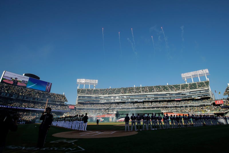 Fans at Oakland Coliseum listen as the national anthem is performed before an American League wild-card baseball game between the Oakland Athletics and the Tampa Bay Rays in Oakland, Calif., Wednesday, Oct. 2, 2019