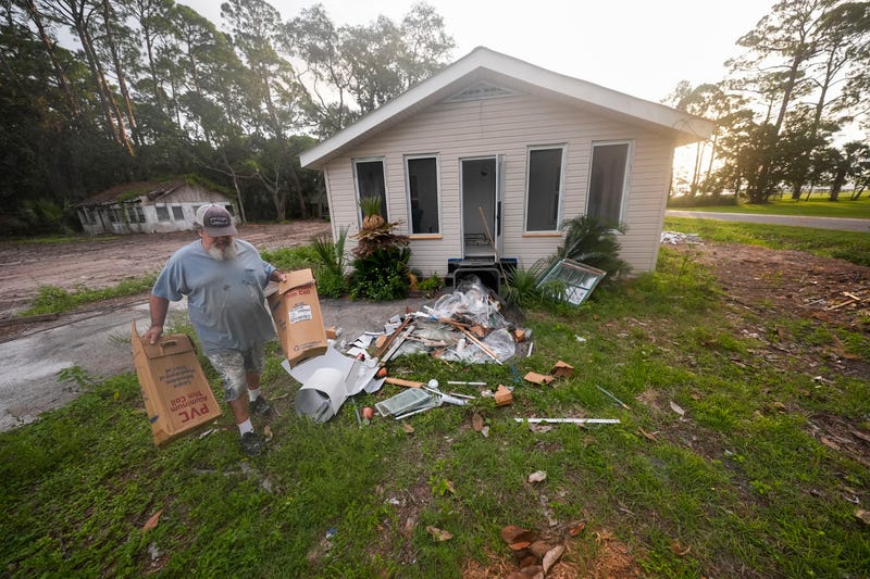 Will Marx cleans up remodeling debris in advance of Tropical Storm Helene, which on Wednesday became a hurricane, in Panacea, Florida, on Sept. 25, 2024.