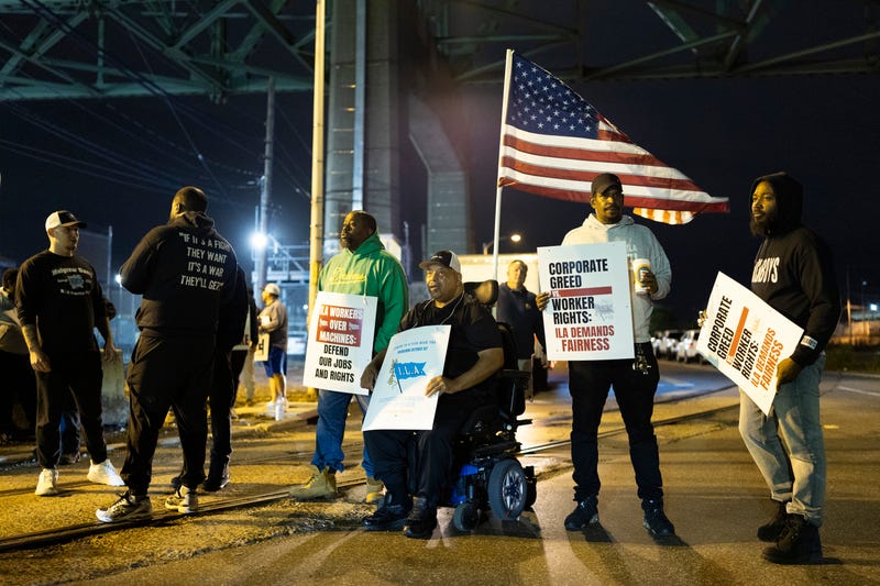 Boise Butler, president of Local 1291, with an American flag on his wheelchair, pickets with his fellow longshoremen outside the Packer Avenue Marine Terminal Port in Philadelphia on Oct. 1, 2024.